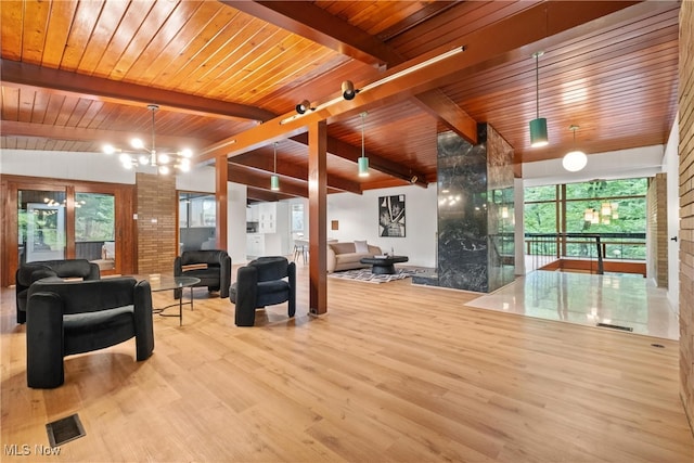 living room with wood ceiling, light hardwood / wood-style flooring, and a wealth of natural light