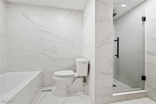 bathroom featuring tile patterned flooring, tile walls, toilet, and plus walk in shower