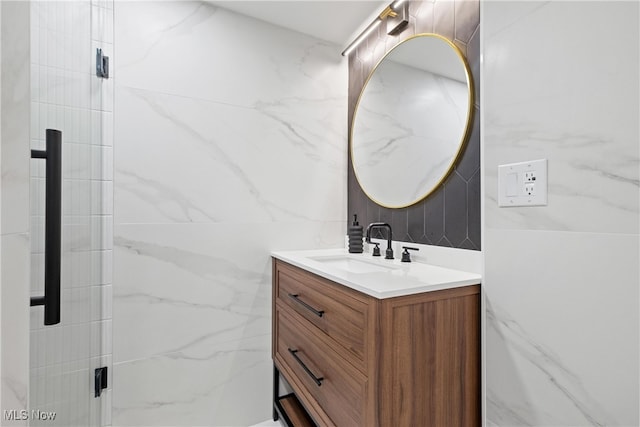 bathroom featuring tile walls, vanity, and a shower with shower door