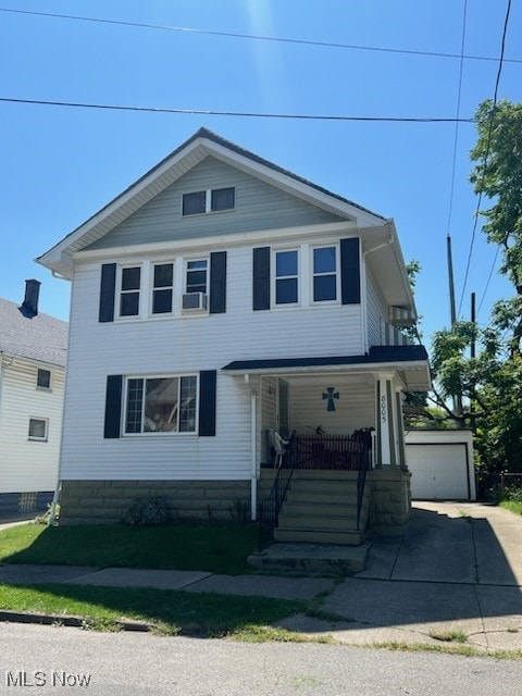 view of front of house featuring covered porch, an outbuilding, and a garage