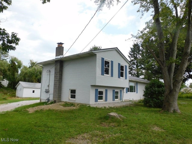 view of side of home with a yard