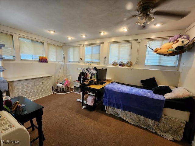 bedroom featuring multiple windows and dark colored carpet