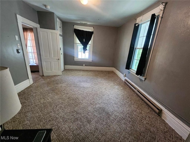 spare room with baseboards and carpet flooring