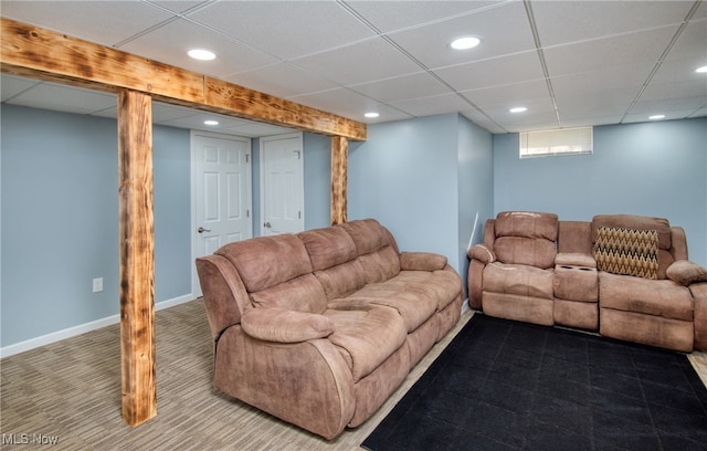 carpeted living room featuring a paneled ceiling