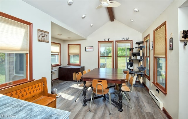 dining room featuring ceiling fan, vaulted ceiling with beams, wood-type flooring, and baseboard heating