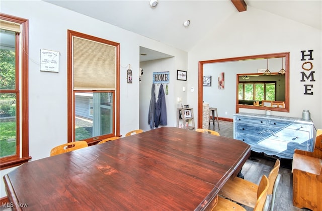 dining room featuring hardwood / wood-style floors and lofted ceiling with beams