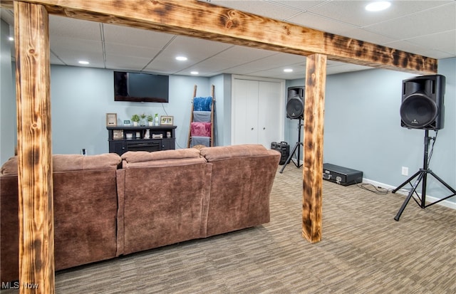 living room with carpet floors and a paneled ceiling