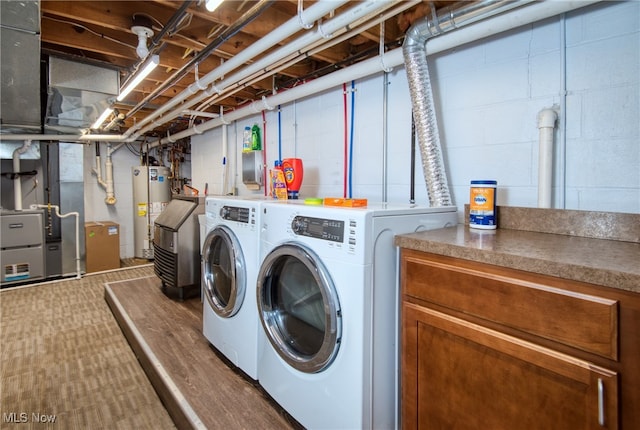 laundry area with washer and dryer, heating unit, and water heater