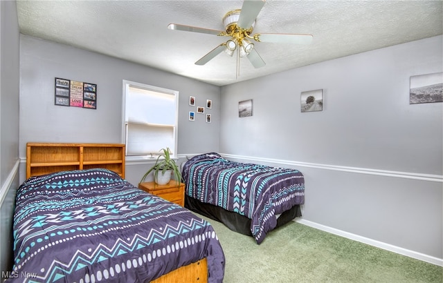 bedroom featuring ceiling fan, a textured ceiling, and carpet floors