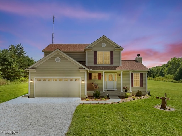 front of property featuring a lawn and a garage