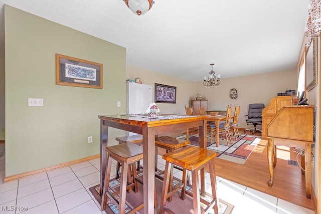 dining room with an inviting chandelier and light wood-type flooring