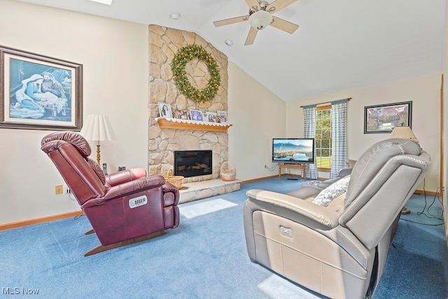 living room featuring lofted ceiling, carpet, a stone fireplace, and ceiling fan