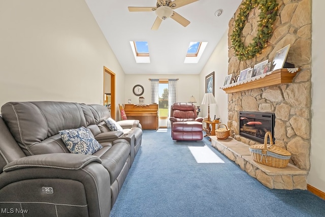 carpeted living room with a stone fireplace, high vaulted ceiling, and ceiling fan