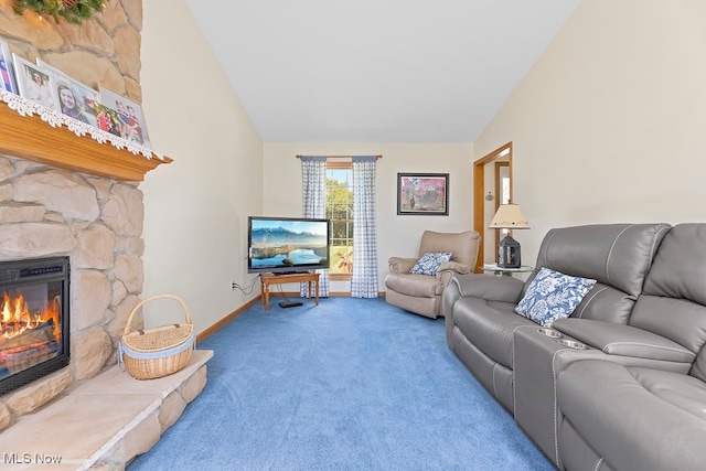 living room with vaulted ceiling, a fireplace, and carpet floors