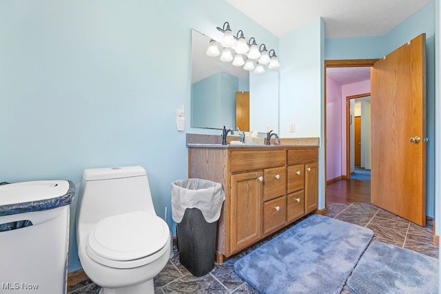 bathroom with vanity, toilet, and hardwood / wood-style flooring