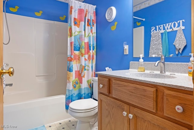 full bathroom featuring vanity, shower / tub combo, and toilet