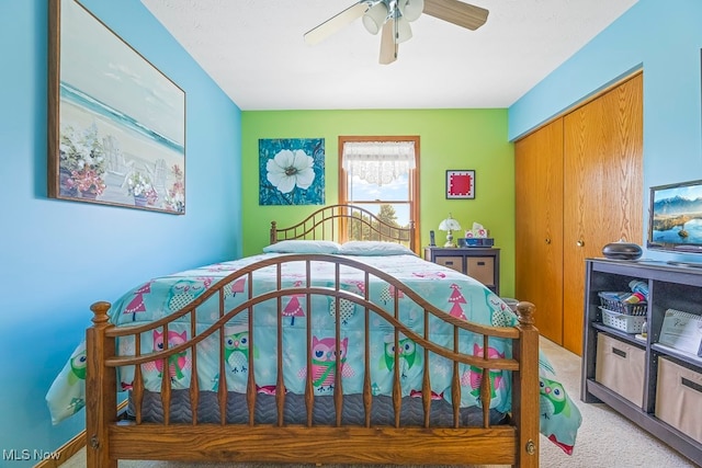 carpeted bedroom featuring a closet and ceiling fan