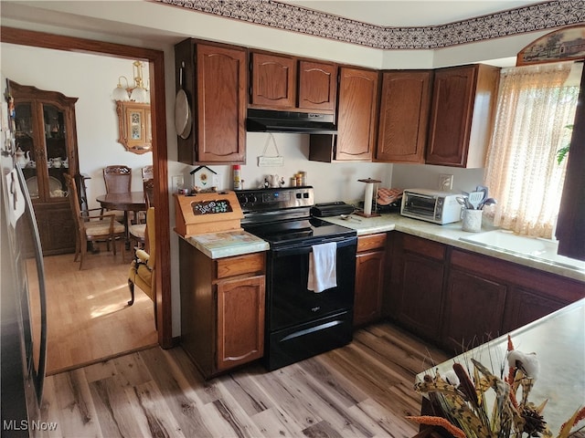 kitchen with wood-type flooring and electric range