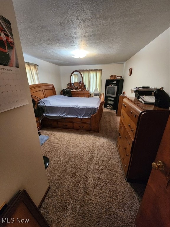 bedroom with carpet and a textured ceiling