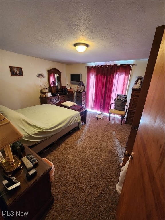 carpeted bedroom featuring a textured ceiling