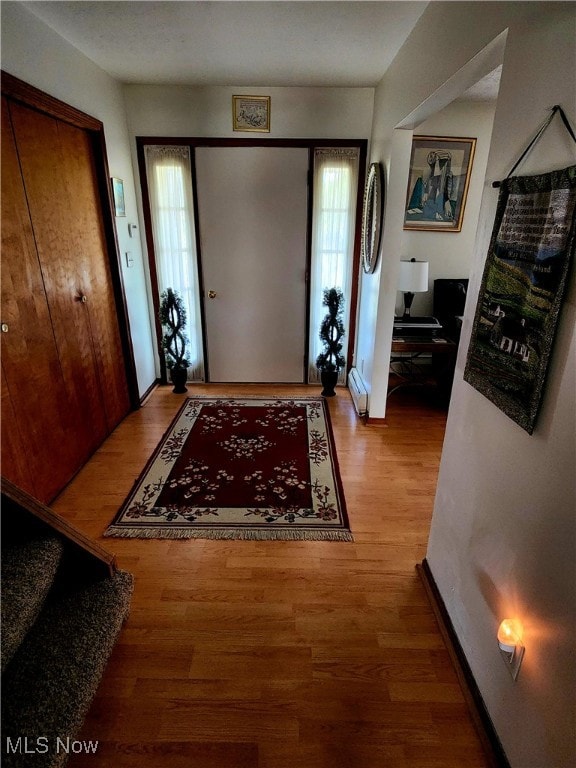 entryway featuring wood-type flooring and a baseboard radiator