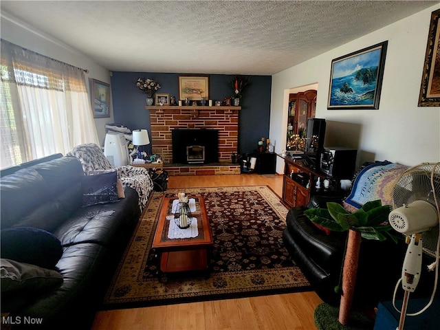 living room featuring a textured ceiling and hardwood / wood-style flooring