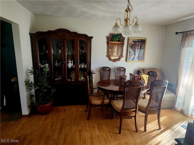 dining room featuring an inviting chandelier and hardwood / wood-style flooring