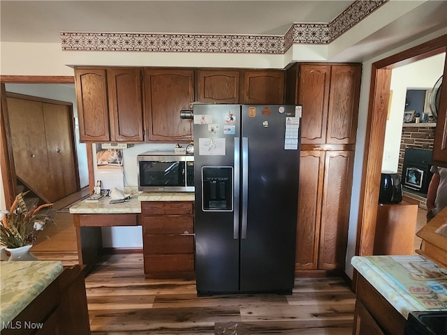 kitchen featuring appliances with stainless steel finishes and dark hardwood / wood-style floors