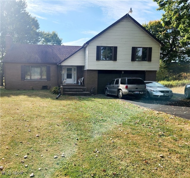 split level home featuring a front yard and a garage