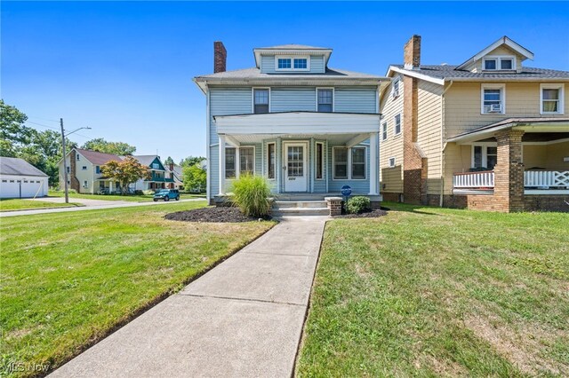 view of front facade featuring a front lawn and covered porch