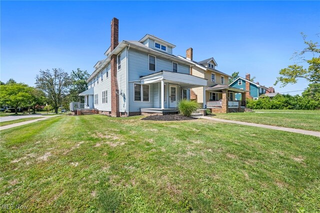 view of front of house featuring a front lawn and covered porch