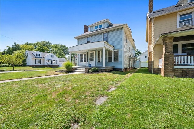 view of front of property with a front lawn, a porch, and cooling unit