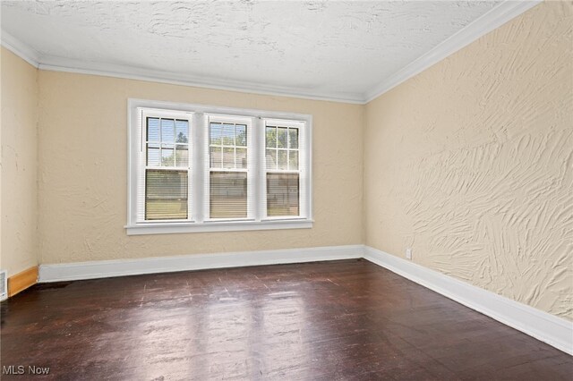 spare room featuring a textured ceiling, crown molding, and hardwood / wood-style floors