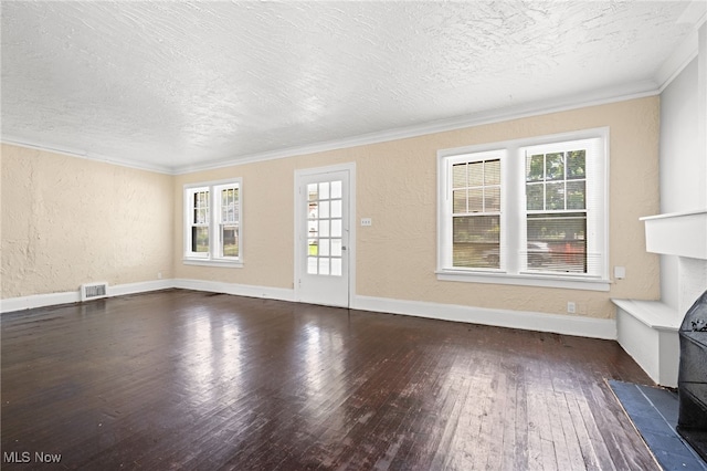 unfurnished living room with dark wood-style floors, visible vents, ornamental molding, and a textured wall