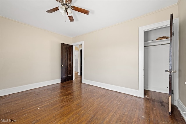 unfurnished bedroom featuring ceiling fan, a closet, crown molding, and dark hardwood / wood-style floors