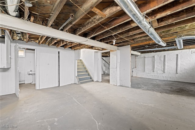 unfinished basement featuring stairs