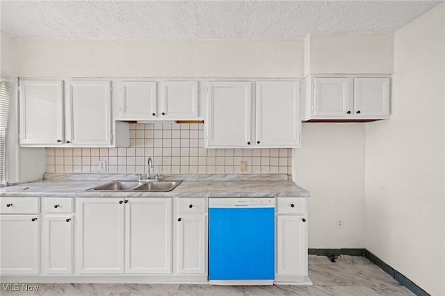 kitchen featuring baseboards, white cabinets, marble finish floor, white dishwasher, and a sink