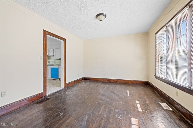 spare room with hardwood / wood-style flooring, a textured ceiling, and a healthy amount of sunlight