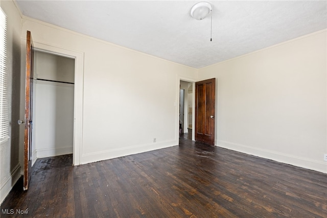 unfurnished bedroom with hardwood / wood-style floors, ornamental molding, a closet, and a textured ceiling