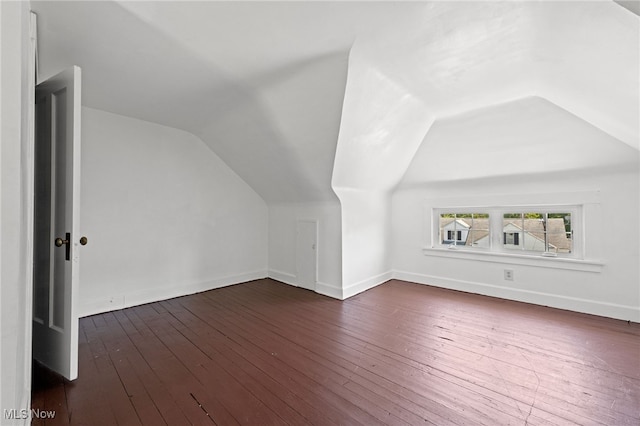 bonus room with vaulted ceiling and wood-type flooring