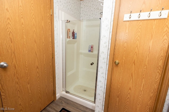 bathroom featuring hardwood / wood-style floors and an enclosed shower