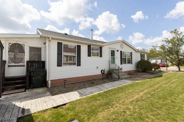 rear view of house with a lawn