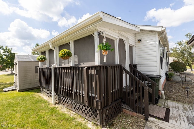 exterior space with a front yard, a storage unit, and a deck