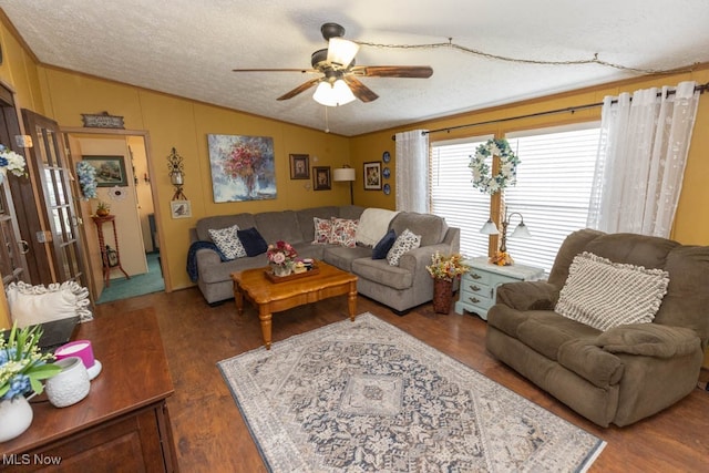 living room featuring a textured ceiling, vaulted ceiling, hardwood / wood-style floors, and ceiling fan