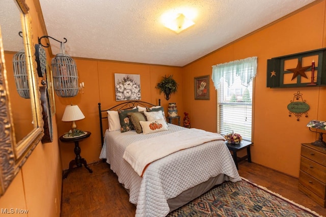 bedroom featuring lofted ceiling, dark wood-type flooring, ornamental molding, and a textured ceiling