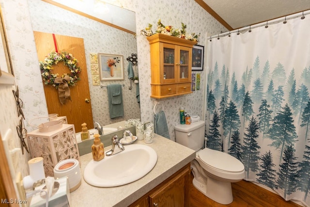 bathroom featuring toilet, ornamental molding, vanity, a textured ceiling, and wood-type flooring