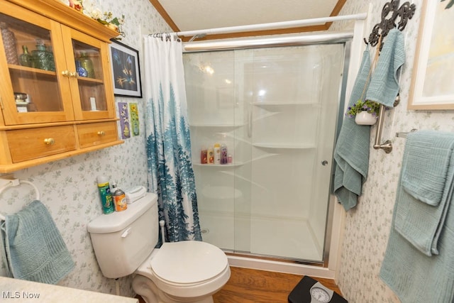 bathroom with a shower with shower curtain, toilet, and hardwood / wood-style flooring