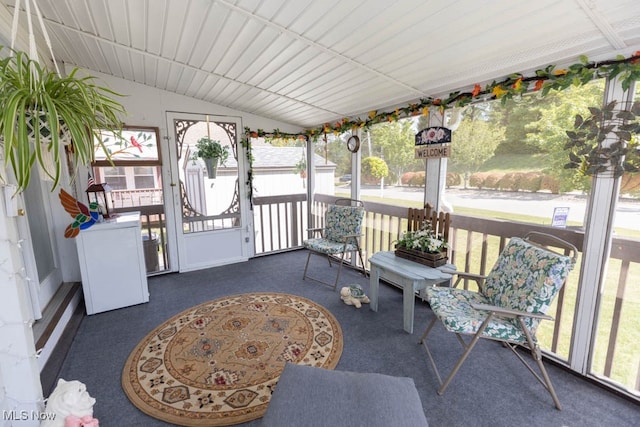 sunroom with vaulted ceiling and a healthy amount of sunlight