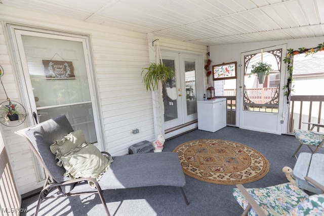 sunroom featuring baseboard heating and french doors