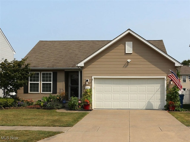 view of front facade featuring a garage and a front lawn